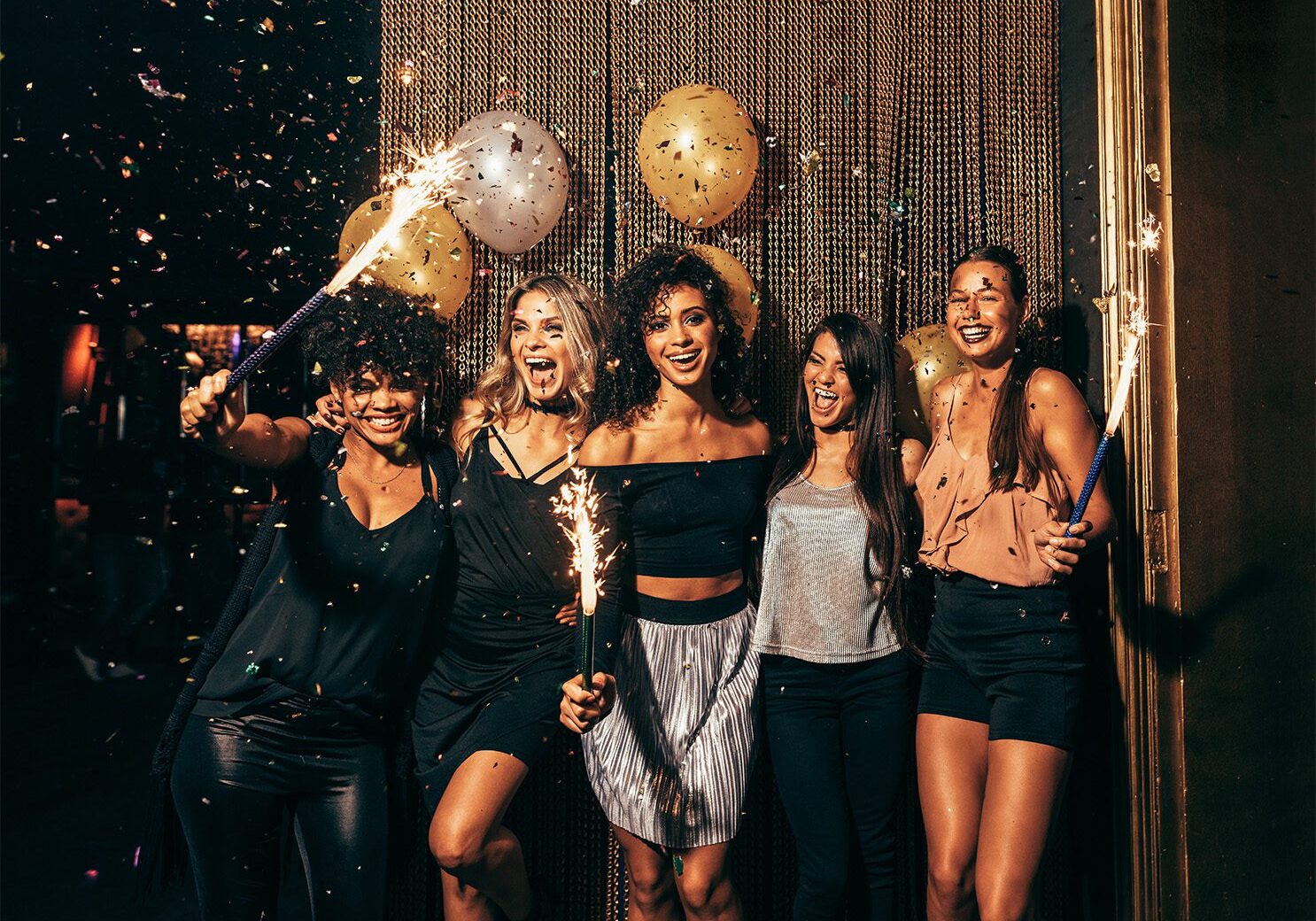 Shot of group of young women celebrating new years eve at the pub